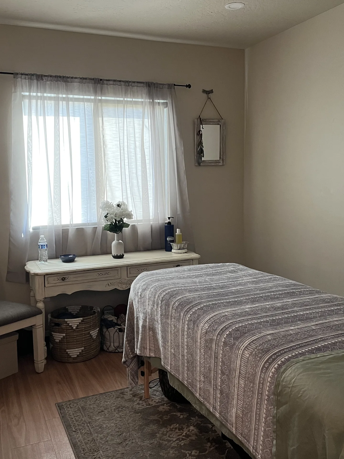 The massage room at Frenchtown Wellness Studio, with the table made up beside the window