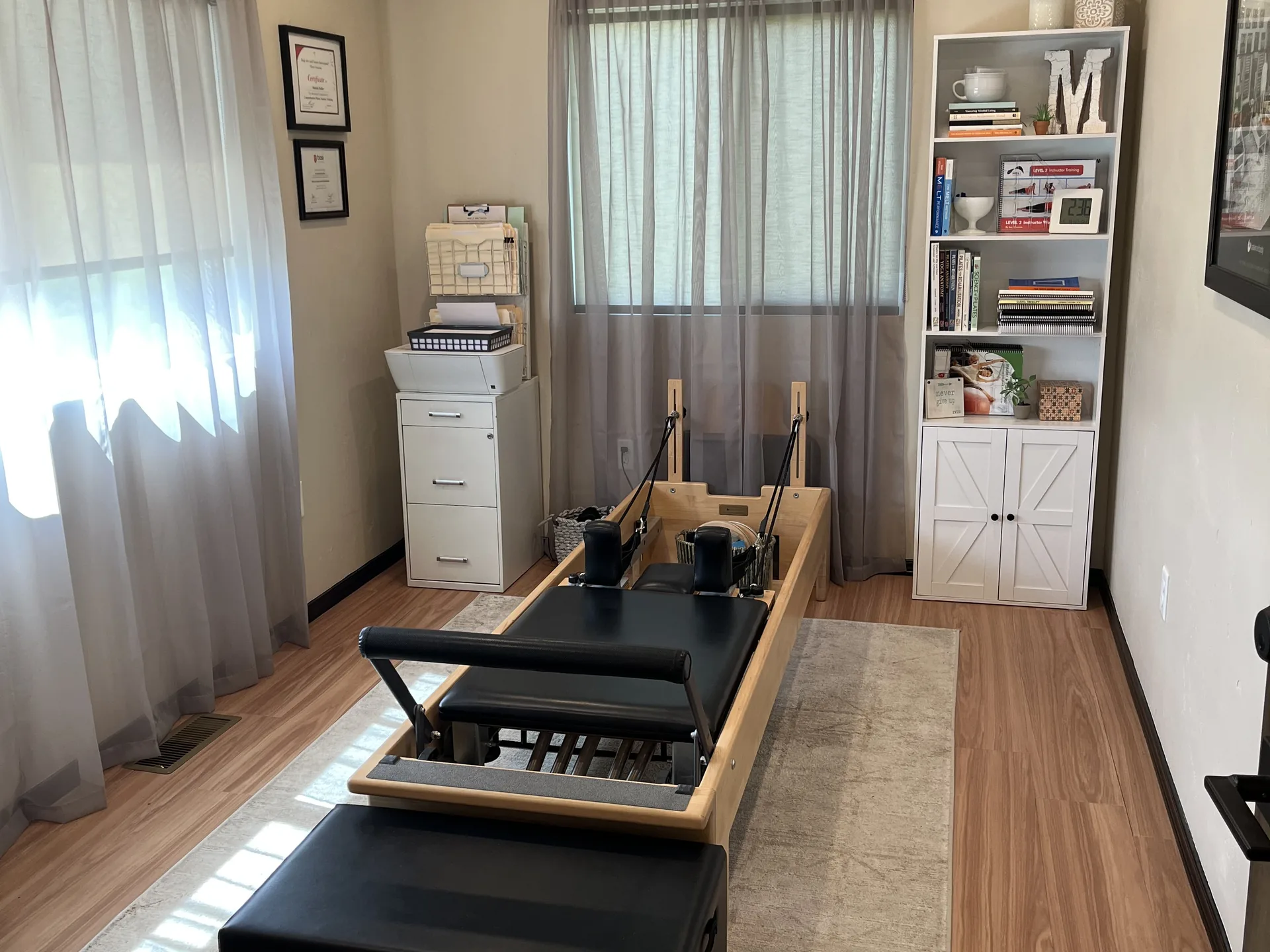 The Pilates room, with the reformer and Michele&rsquo;s certificates