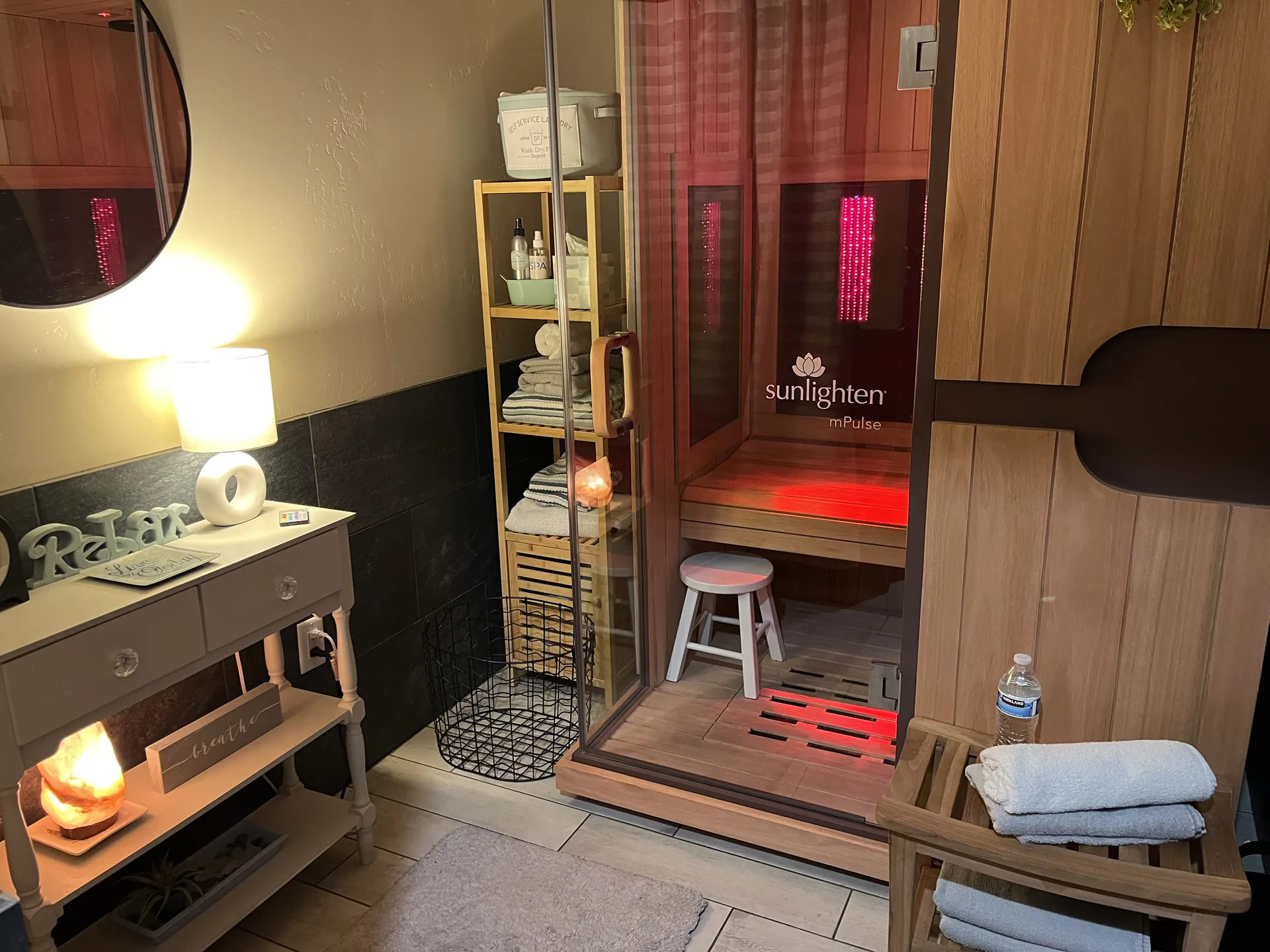 The Sunlighten infrared sauna cabin, lit from within