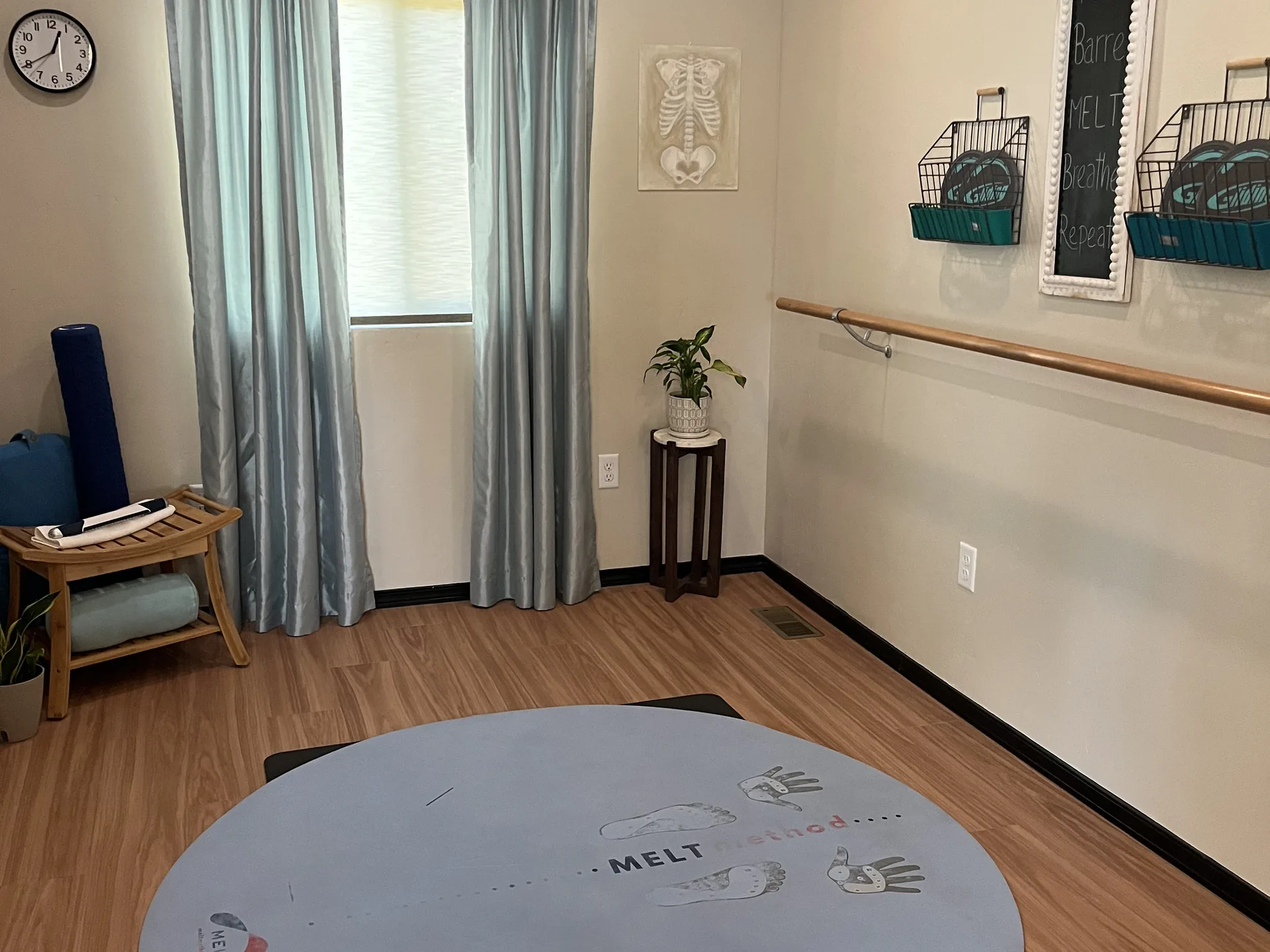 The MELT room, with a MELT Method mat, a barre and the studio&rsquo;s chalkboard